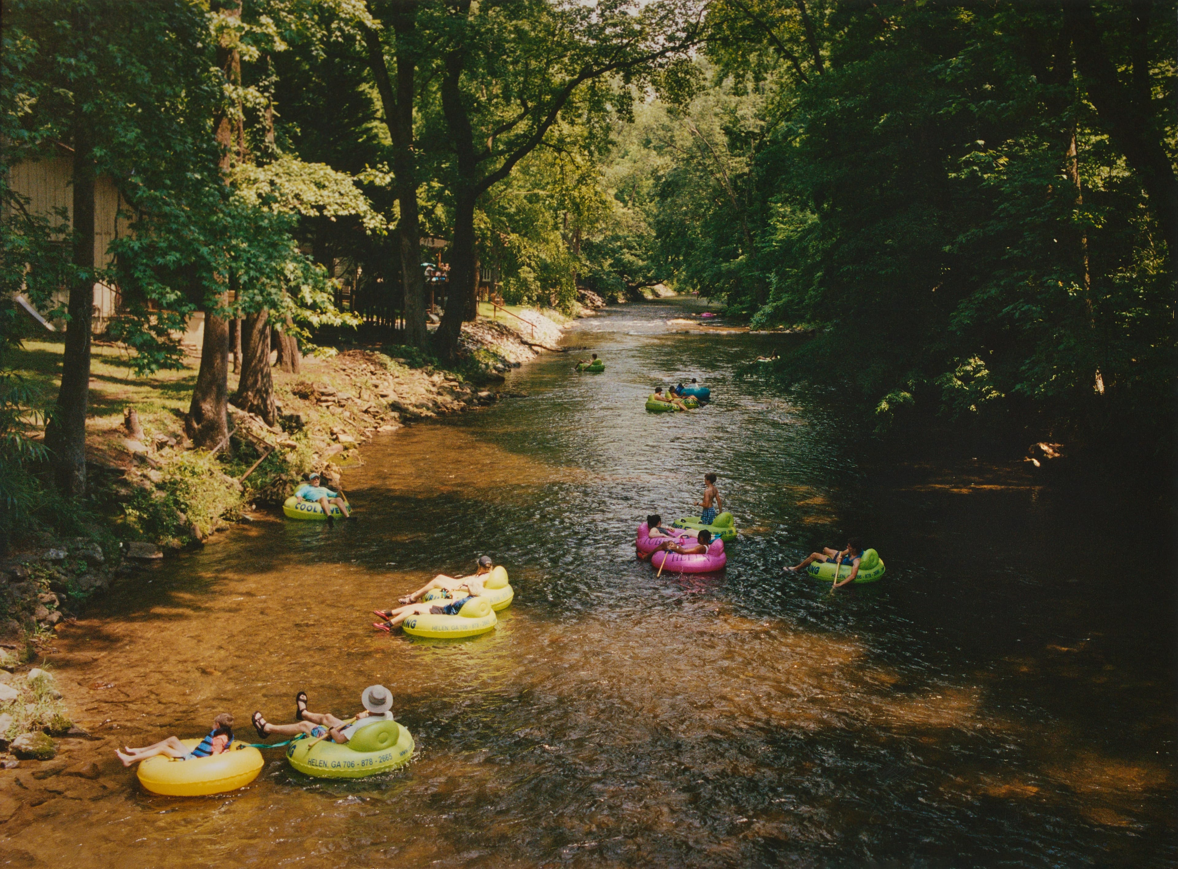 People float in colorful inflatable tubes down a stretch of the Chattahoochee River near Helen, Georgia